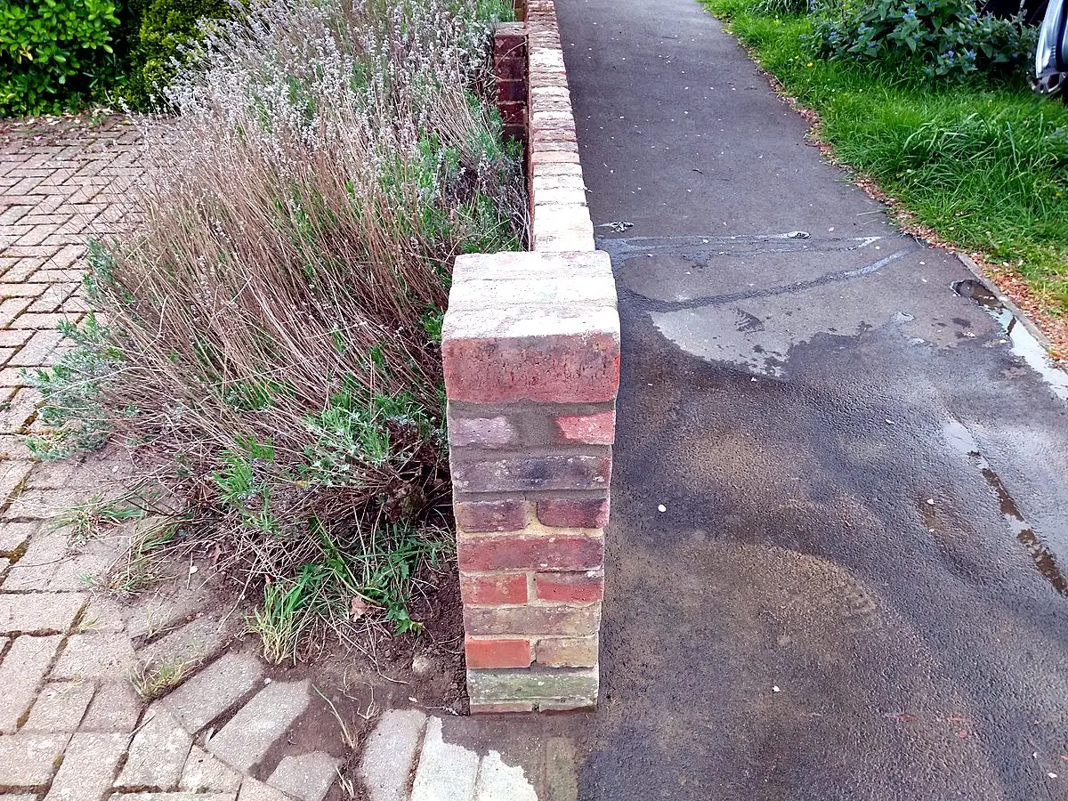 Rebuilt brick pillar and wall after repair