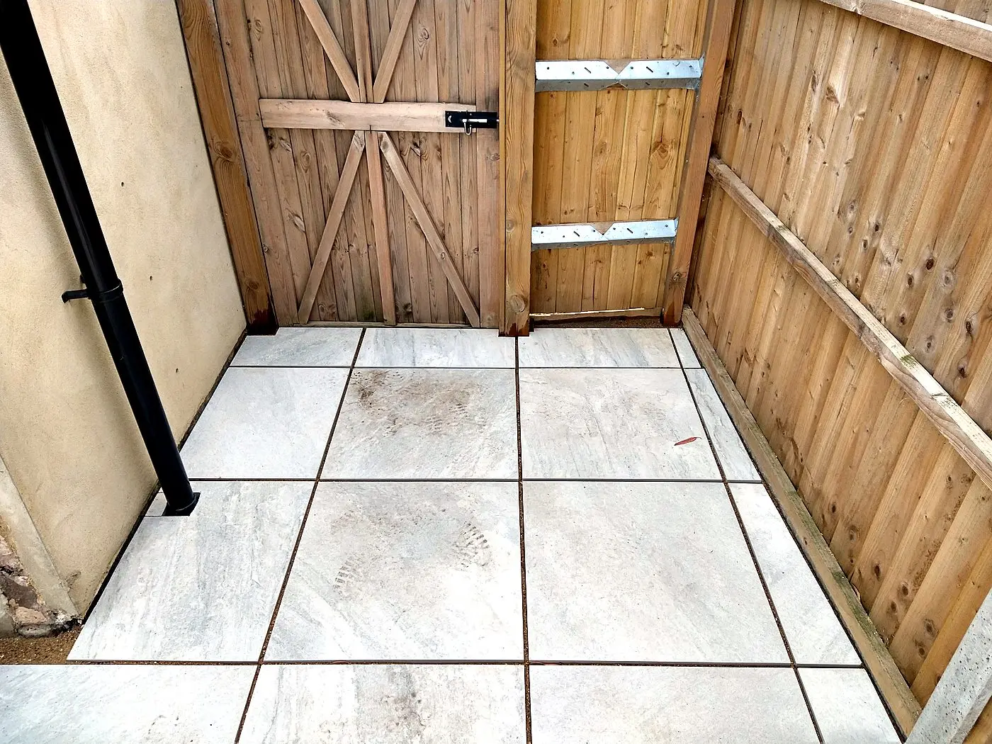 Vertical timber fence and braced garden gate with slide-bolt latch